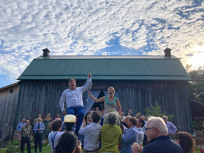 Wedding guests celebrating outside the Brooklands Farm heritage barn