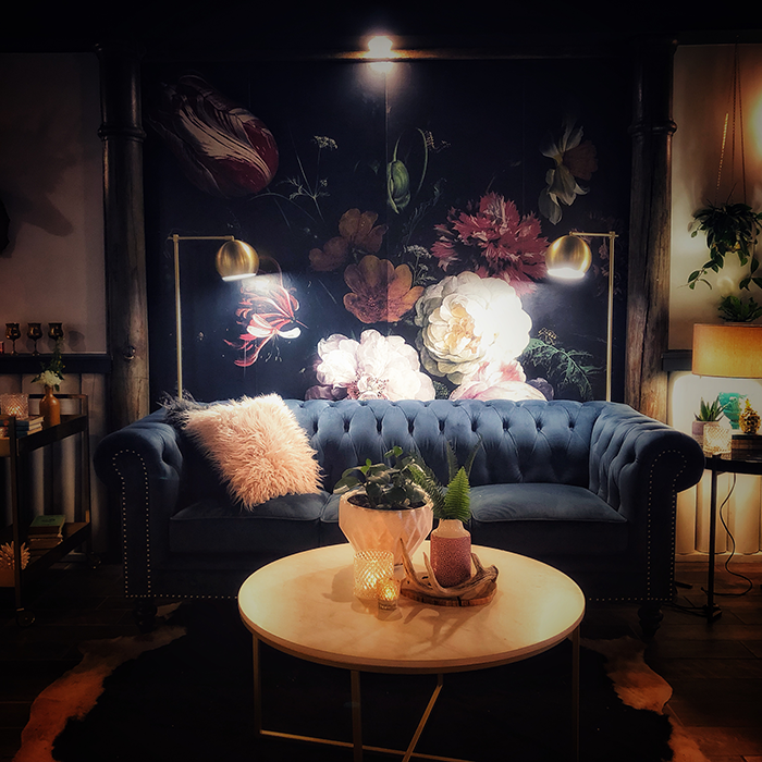 Blue velvet sofa and dramatic floral artwork at The Northridge Inn and Resort