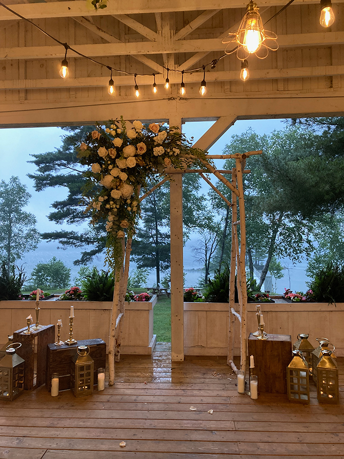 Covered wedding ceremony setup overlooking a rainy Lake Bernard at The Northridge Inn and Resort