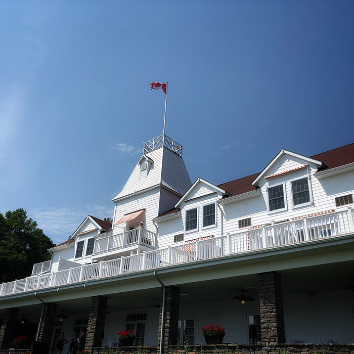 The historic white exterior and Canadian flag at Windermere House